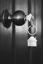 House key in wooden front door in black and white color tone Royalty Free Stock Photo