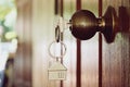 House key in wooden front door Royalty Free Stock Photo