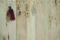 House key with wooden home keyring hanging on wood board background, property concept, copy space Royalty Free Stock Photo