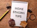 House keychain and notebook with the word HOME STAGING TIPS