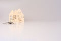 close-up house keys against the background of wooden house models. selective focus. investment, mortgage, real estate