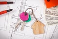 House keys, currencies dollar, electrical construction diagrams and work tools for engineering jobs. Building or buying home Royalty Free Stock Photo