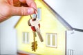 House keys in the hands against the background of the finished built yellow building Royalty Free Stock Photo