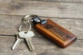 House keys with wooden home keying on wood table, copy space, property concept Royalty Free Stock Photo