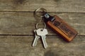 House keys with wooden home keying on wood table, copy space, property concept Royalty Free Stock Photo