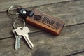 House keys with wooden home keying on wood table, copy space, property concept Royalty Free Stock Photo