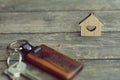 House keys with wooden home keying on wood table, copy space, property concept Royalty Free Stock Photo