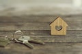 House keys with wooden home keying on wood table, copy space, property concept Royalty Free Stock Photo