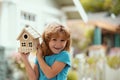 House in kids hands. Family home, home protecting insurance concept, Child boy building house, home care. Happy kid Royalty Free Stock Photo