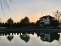 House by the lake. Reflection of a house in the water. Mansion by the river at sunset. The cottage is near the reservoir. Kiev Royalty Free Stock Photo