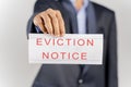 House Landlord or lawyer in suit showing eviction notice on isolated background.