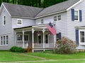 House with large porch and American flag