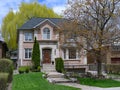 House with large willow tree in spring