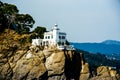 House with lighthouse on rock one Royalty Free Stock Photo