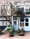 A house in London mews with blue doors and big windows