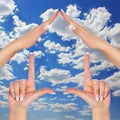 House made of female hands over blue sky with clouds. concept symbol home Royalty Free Stock Photo