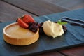 House made mango and passion fruit cheesecake served with fresh Chantilly cream and Royalty Free Stock Photo