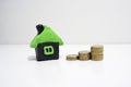 House made from plasticine and some coins near it. Royalty Free Stock Photo