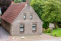 House made of red clincker bricks surrounded by green trees Royalty Free Stock Photo