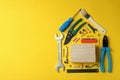 House made of working tools on yellow background Royalty Free Stock Photo