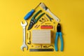 House made of working tools on yellow background Royalty Free Stock Photo