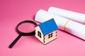 house, magnifier and paper on pink background Royalty Free Stock Photo