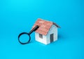 House and magnifying glass. Searching for real estate to buy.