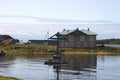 House and the Memorial cross at the Cape Herring. Solovki, Russia