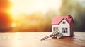 House miniature with keys in the warm morning light. Concept of real estate investment, buying a new home, and property Royalty Free Stock Photo
