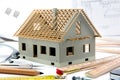 House miniature under construction on an architect desk Royalty Free Stock Photo