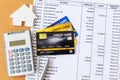 House model and calculator on Bank statement and credit card on a Wooden table. home purchase mortgage concept Royalty Free Stock Photo