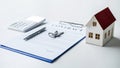 House model, calculator and house key lying on real estate contract, home loan and investment concept Royalty Free Stock Photo