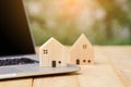 House model with computer laptop on wooden table. loan real estate or property mortgage investment concept Royalty Free Stock Photo