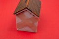 House Model With Crossed Band Aid on red color