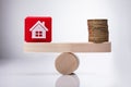 House Model Cubic Block And Golden Coins Balancing On Seesaw Royalty Free Stock Photo