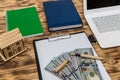 House model with dollars, laptop and clipboard Royalty Free Stock Photo