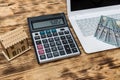 House model with dollars, laptop and clipboard Royalty Free Stock Photo