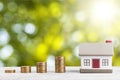 House model and golden coins stacks