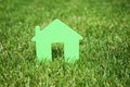 House model on green lawn. Real estate agent