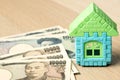 House model with japanese yen bank note on wood background Royalty Free Stock Photo