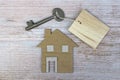 House model and key on wooden desk. Directly above. Flat lay.