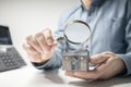 House model with man holding magnifying glass home inspection or searching for a house Royalty Free Stock Photo