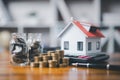 House model and money coins saving for concept saving money for buying a house, investment mortgage finance, and home loan Royalty Free Stock Photo