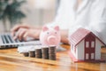 House model and money coins saving for concept saving money for buying a house, investment mortgage finance, and home loan Royalty Free Stock Photo