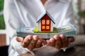 House model and money in hand Royalty Free Stock Photo