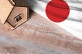 House model near Japan flag. Real estate sale and purchase concept. Royalty Free Stock Photo