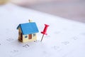 House model and red pin mark on calendar, due date for home payment ,property reminder concept Royalty Free Stock Photo