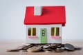 House model with red roof and white walls on metal coins Royalty Free Stock Photo