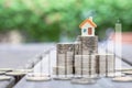 House model on stack of coin with bar char and line graph. Royalty Free Stock Photo