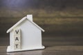 House model with vat word on wooden blocks.